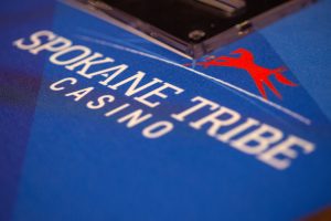 Close up image of the Spokane Tribe Casino logo on a felt tabletop