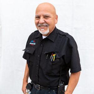 Smiling man with goatee and maintenance uniform