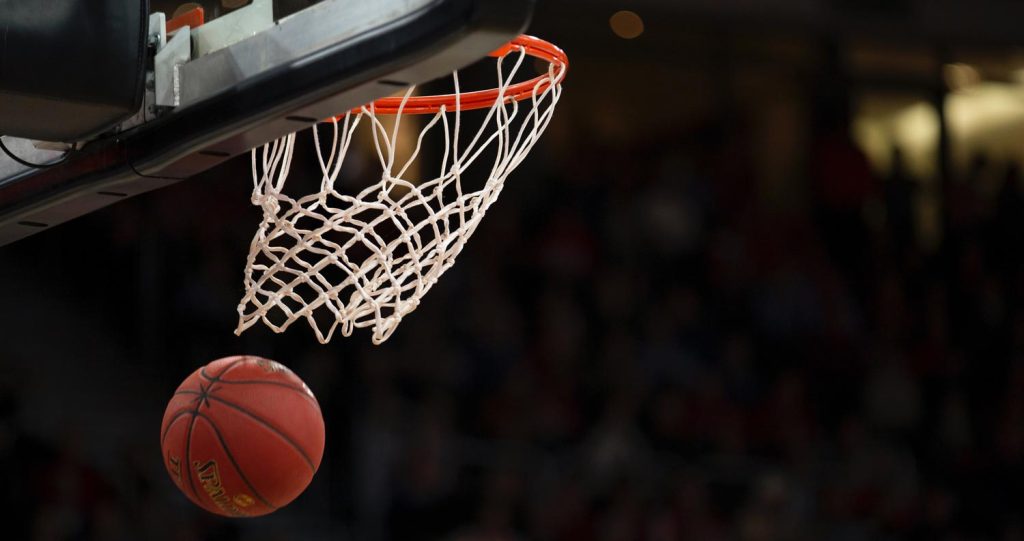 Basketball hoop with basketball swooshing through the net