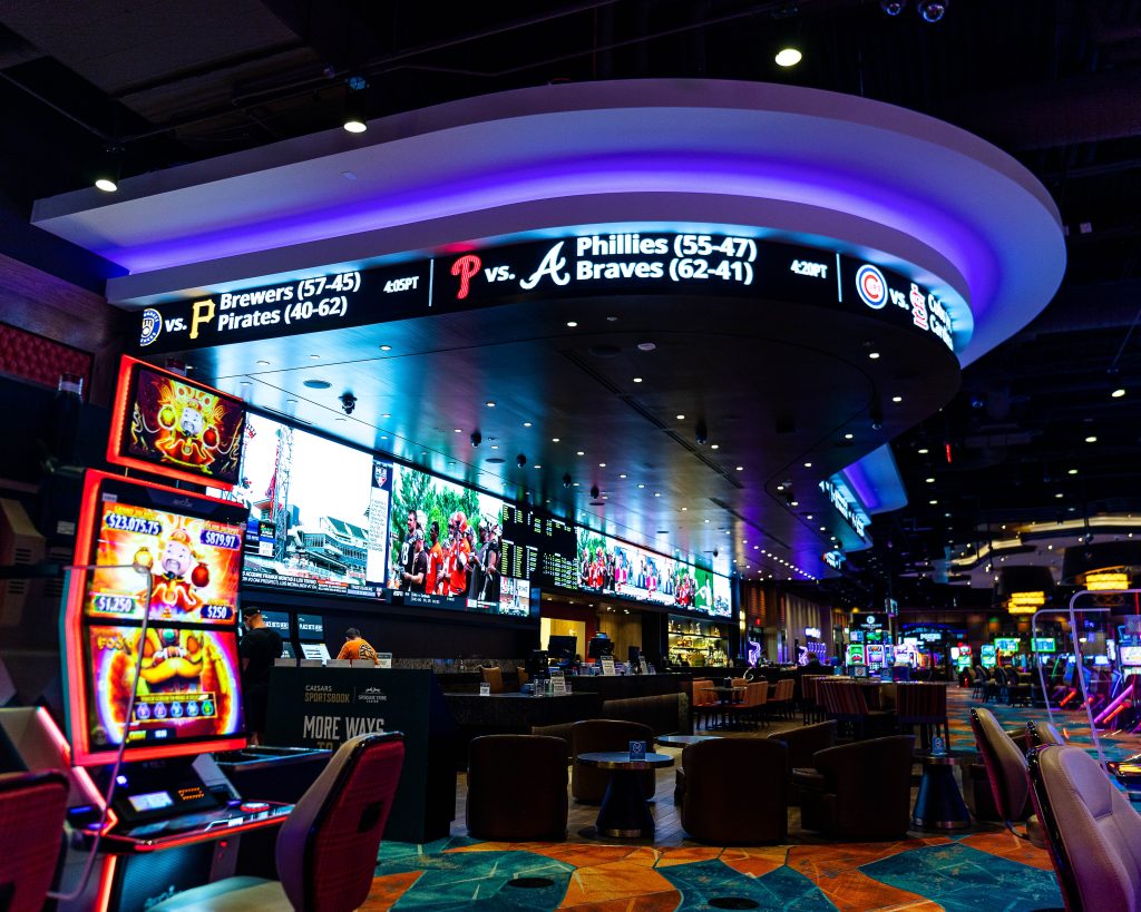 Sports betting section of the Spokane Tribe Casino with multiple screens and giant readerboard going across the top